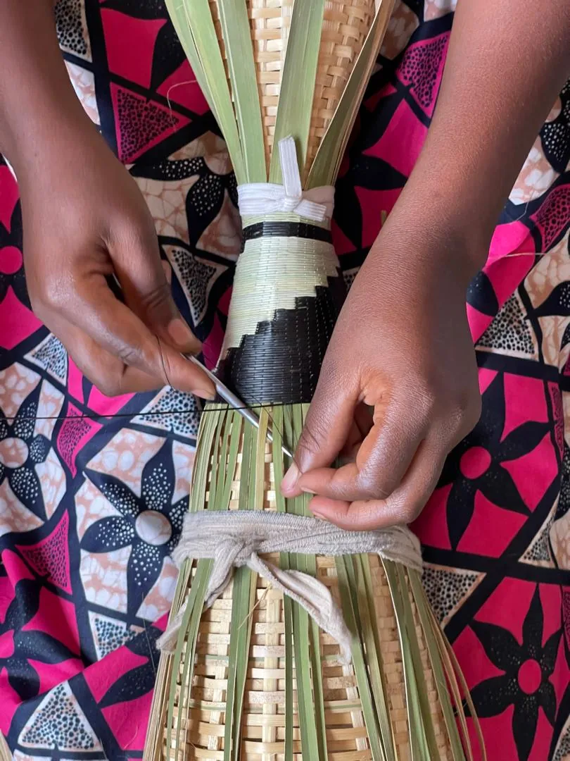 Hands weaving bamboo reed
